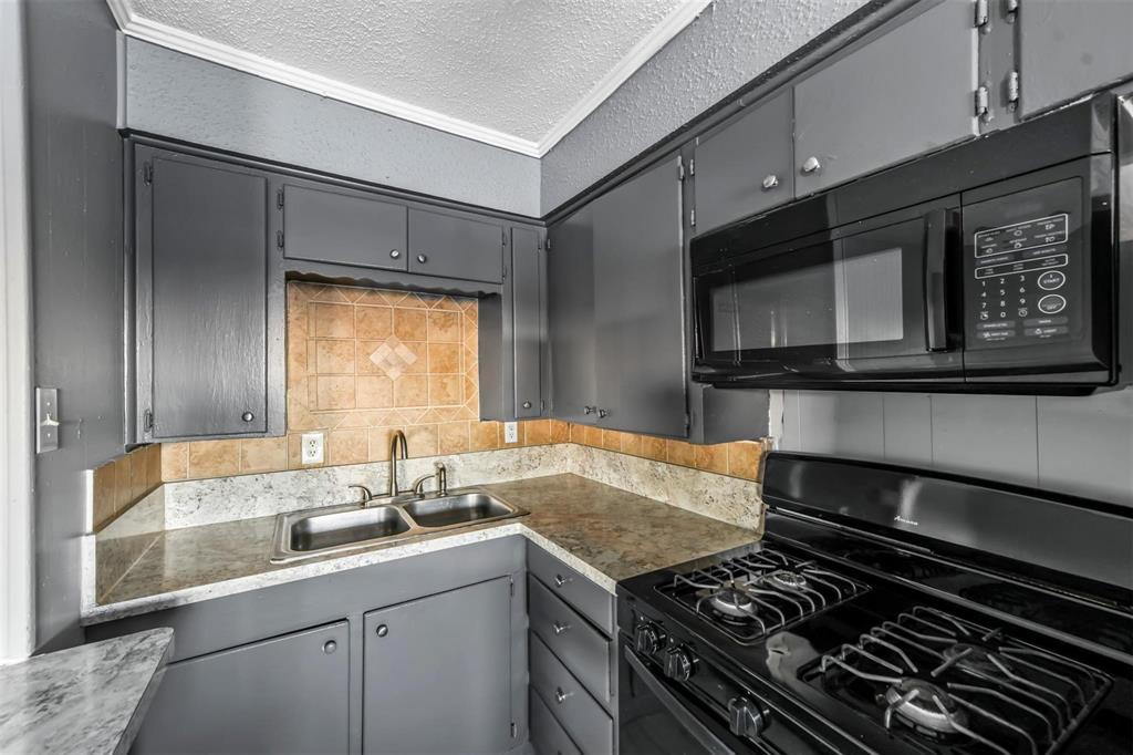 1585 North Mill Street, Unit 5 Lewisville, TX 75057 - Photo 6 of 17 a kitchen with a stove and a microwave