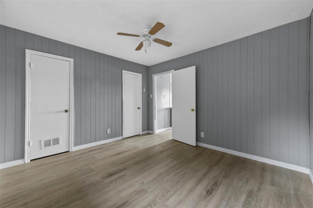 1585 North Mill Street, Unit 5 Lewisville, TX 75057 - Photo 10 of 17 a view of empty room with wooden floor and ceiling fan