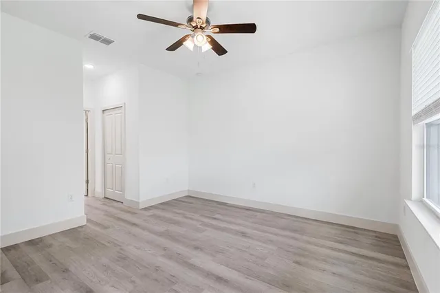 wooden floor in an empty room with a window