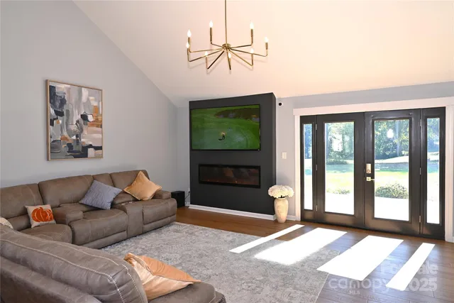 a living room with furniture a window and a flat screen tv