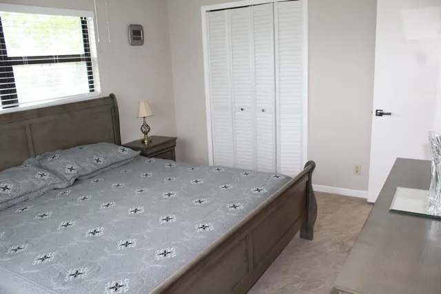 a bedroom with a bed and a window