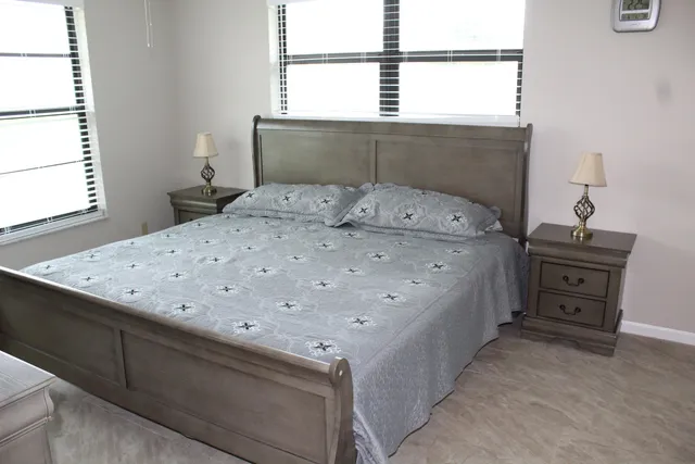 a bed sitting in a bedroom next to a window