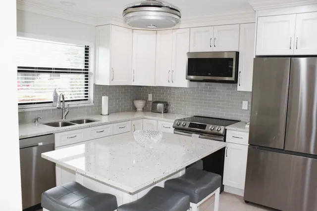a kitchen with a white stove top oven and refrigerator
