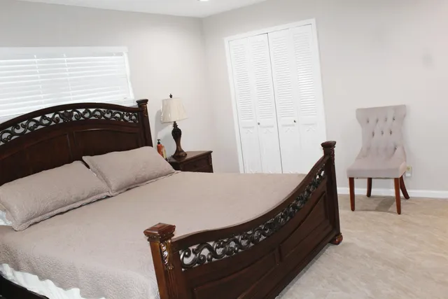 a bedroom with a bed and a table