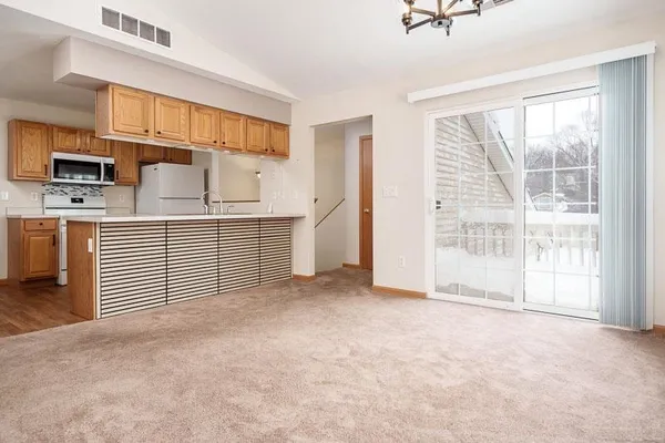 a view of a kitchen with a sink and dishwasher cabinet with wooden floor