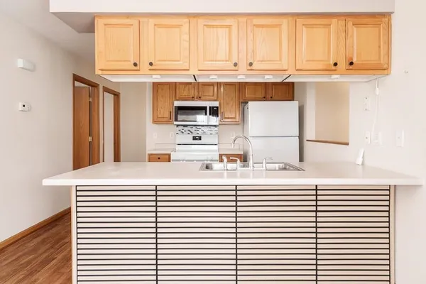 a kitchen with stainless steel appliances and white cabinets