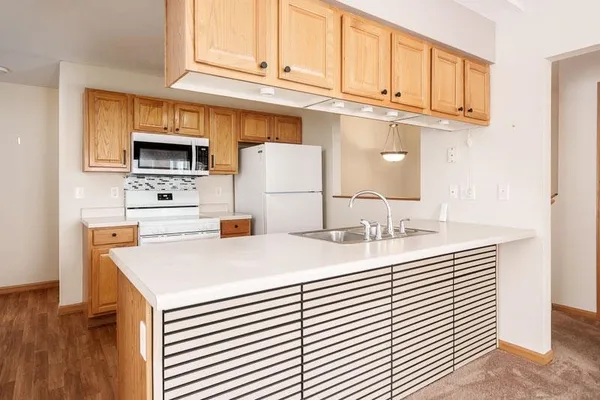 a kitchen with stainless steel appliances granite countertop a sink a stove and cabinets