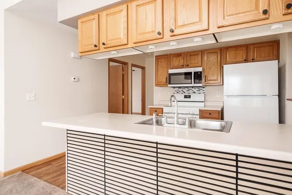 a kitchen with stainless steel appliances cabinets and a window