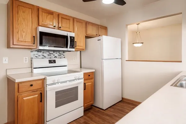 a kitchen with a refrigerator sink stove and microwave