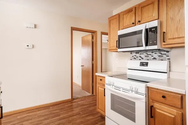 a kitchen with stainless steel appliances granite countertop a stove microwave and refrigerator