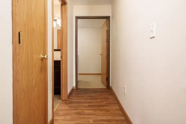 a view of a hallway with wooden floor