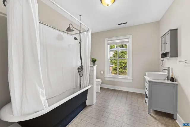 a bathroom with a bathtub and a sink