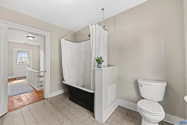 a bathroom with a toilet a sink and shower