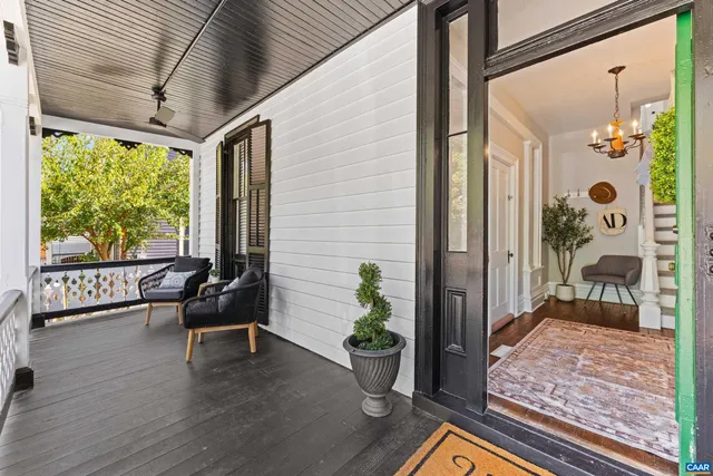 a porch with furniture and wooden floor