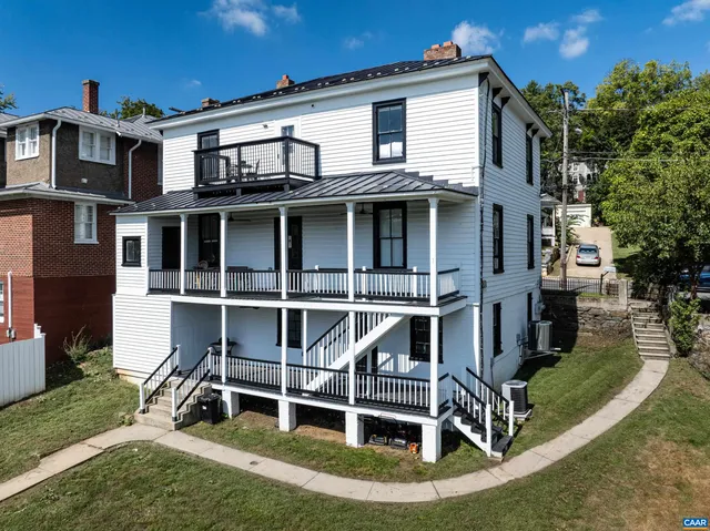 an aerial view of a house with garden space and street view