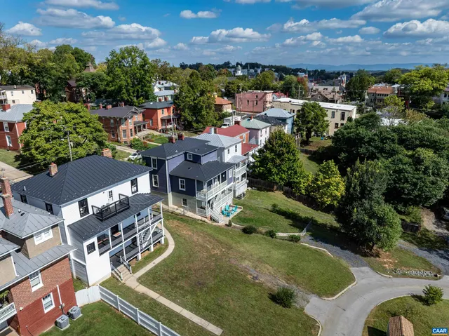 an aerial view of residential house with outdoor space and swimming pool
