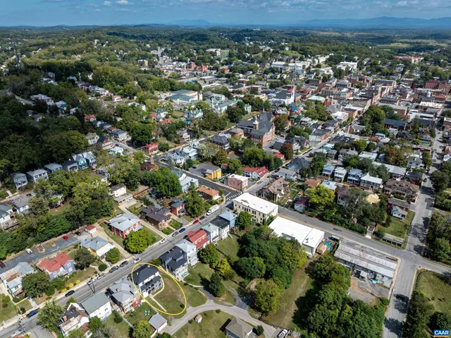 an aerial view of residential houses with outdoor space and street view