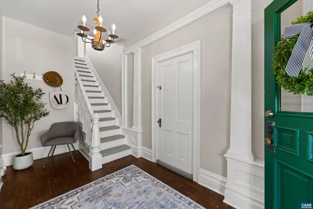 a view of entryway with furniture and wooden floor