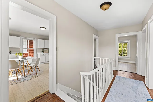 a view of a hallway to dining room and wooden floor