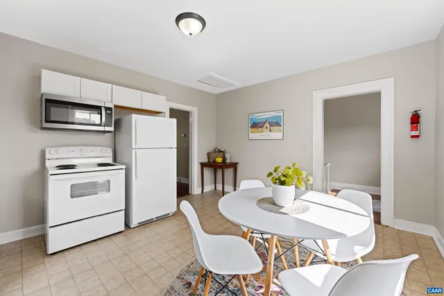 a kitchen with a refrigerator and microwave