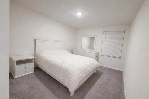 a bedroom with a bed and a lamp