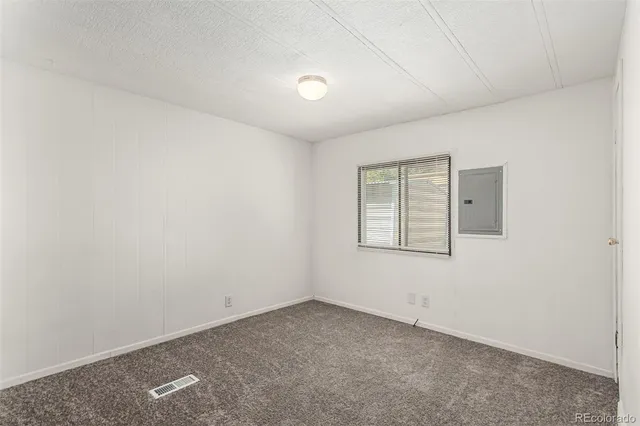 an empty room with closet area