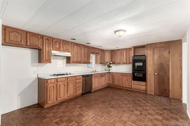 a large kitchen with kitchen island a sink stainless steel appliances and cabinets