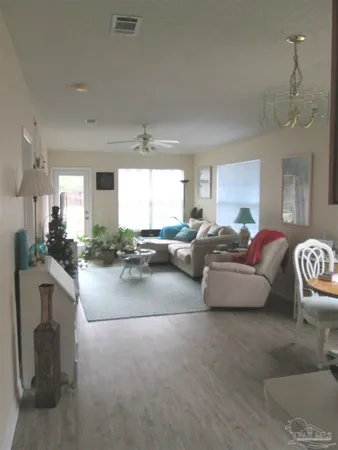 a living room with furniture and a chandelier