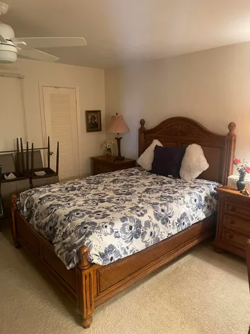 a bedroom with a bed and a night stand