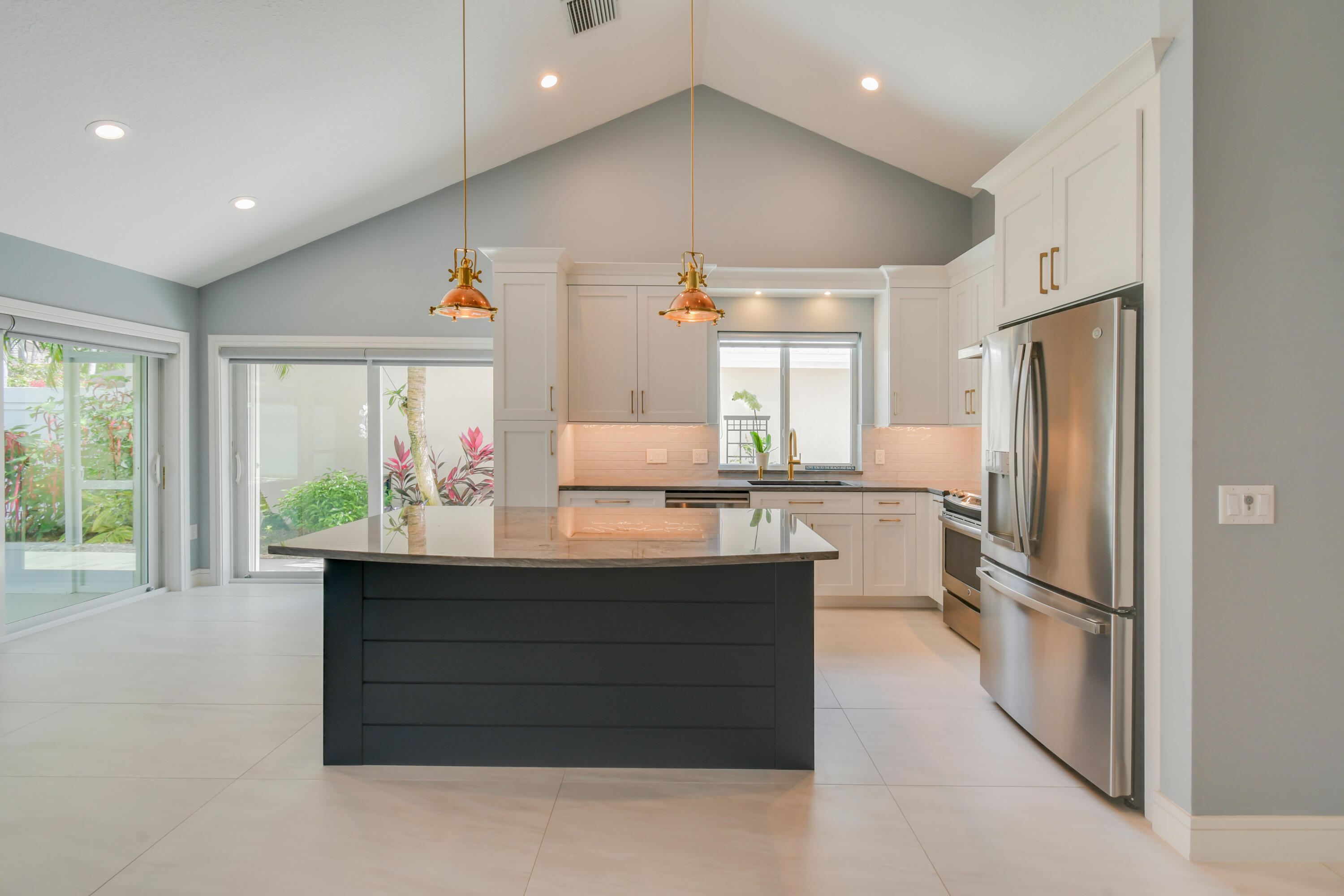 438 River Edge Road Jupiter, FL 33477 - Photo 16 of 80 a kitchen with counter top space and refrigerator