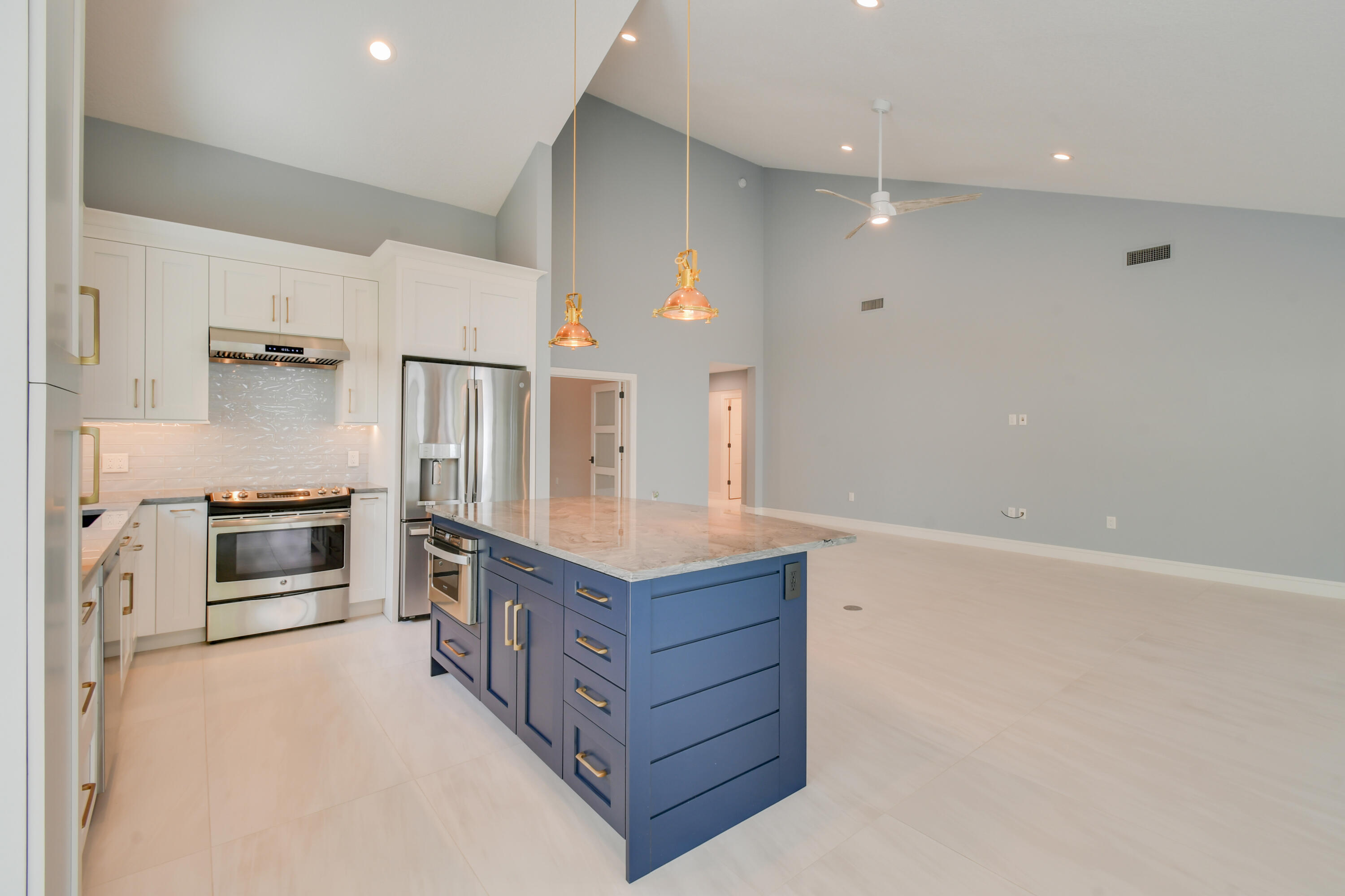 438 River Edge Road Jupiter, FL 33477 - Photo 20 of 80 a kitchen with granite countertop a refrigerator and a stove