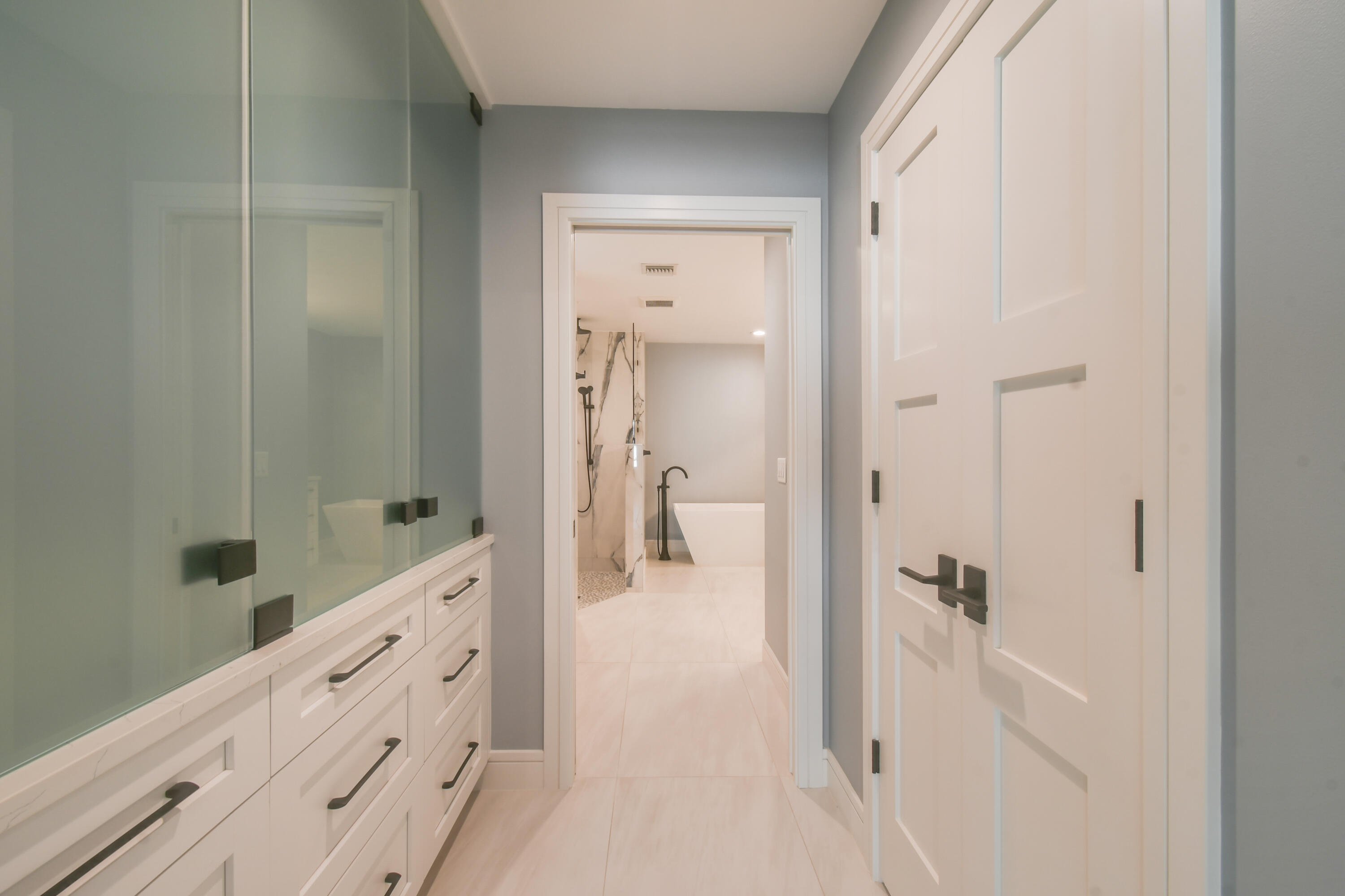 438 River Edge Road Jupiter, FL 33477 - Photo 28 of 80 Hall to Master Bath with custom closets