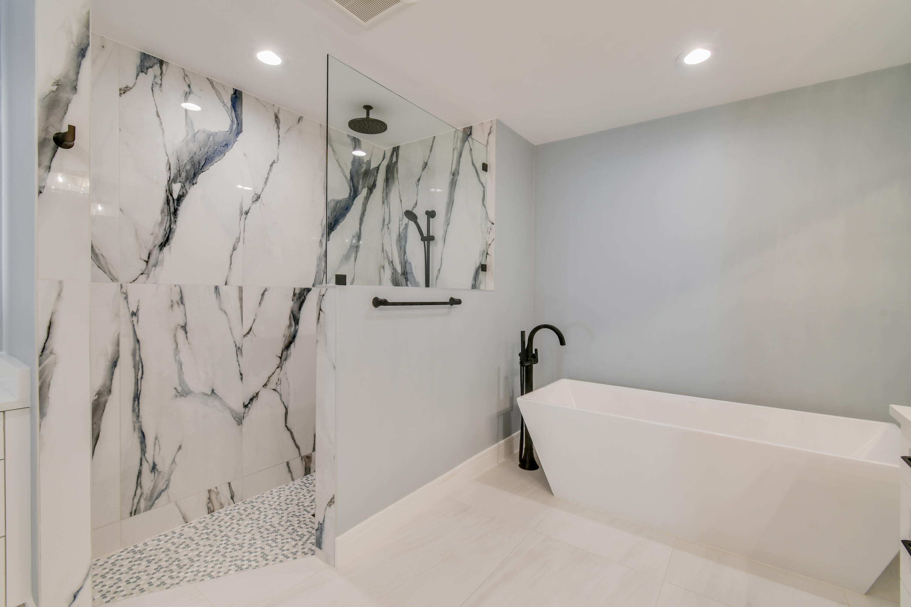 438 River Edge Road Jupiter, FL 33477 - Photo 34 of 80 a bathroom with a bathtub and a shower