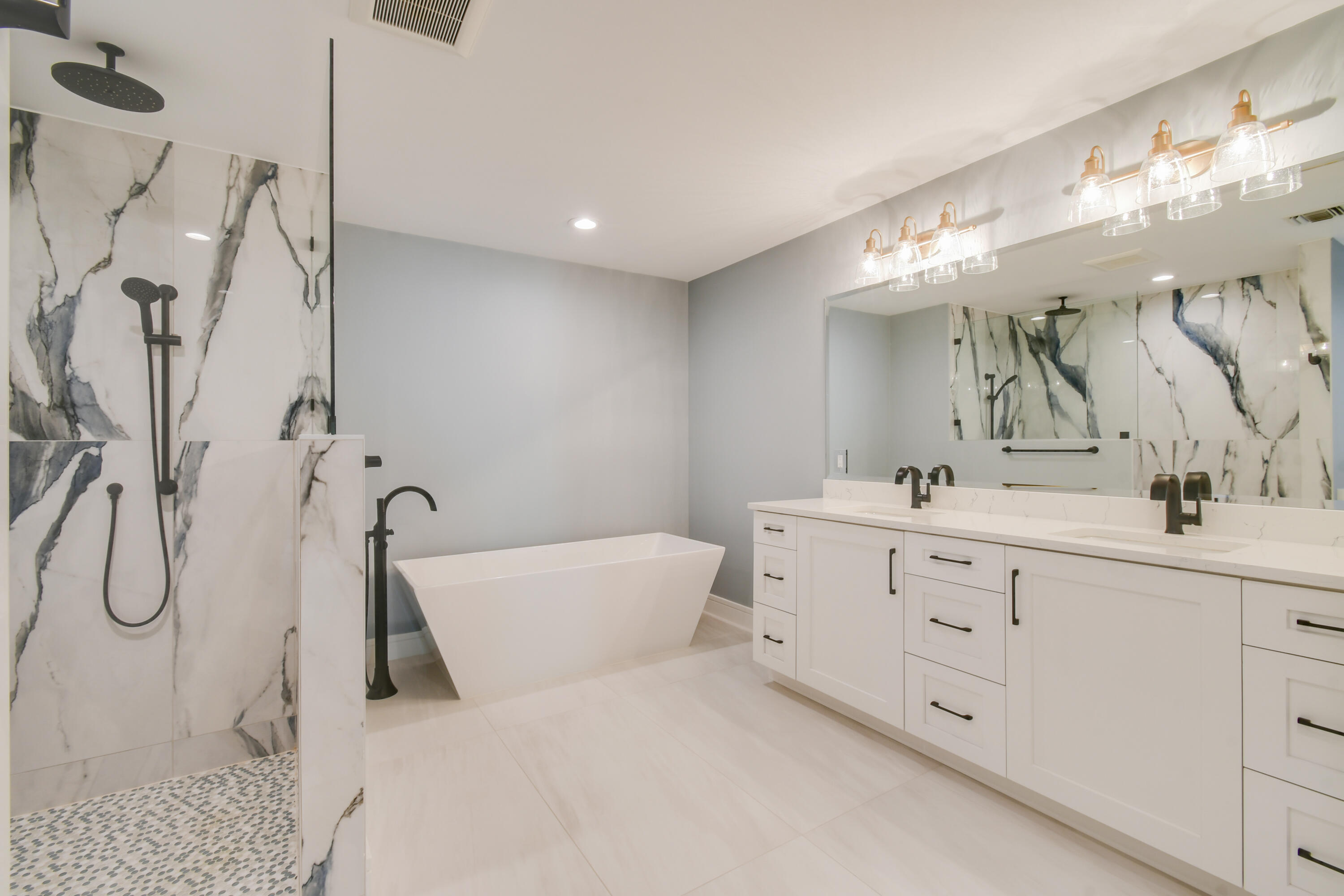 438 River Edge Road Jupiter, FL 33477 - Photo 36 of 80 a spacious bathroom with a double vanity sink mirror and shower