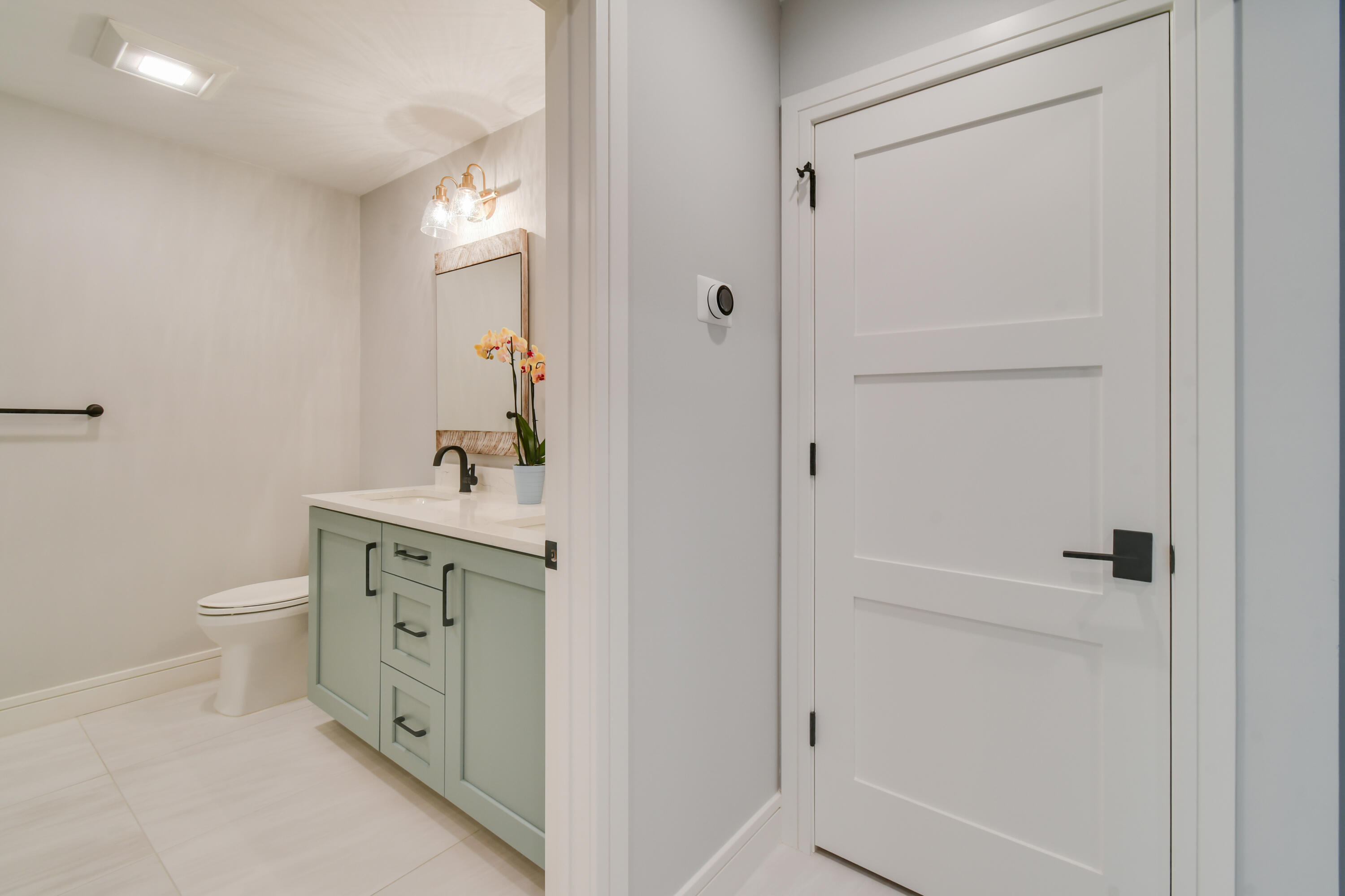 438 River Edge Road Jupiter, FL 33477 - Photo 44 of 80 a bathroom with a sink a toilet and shower