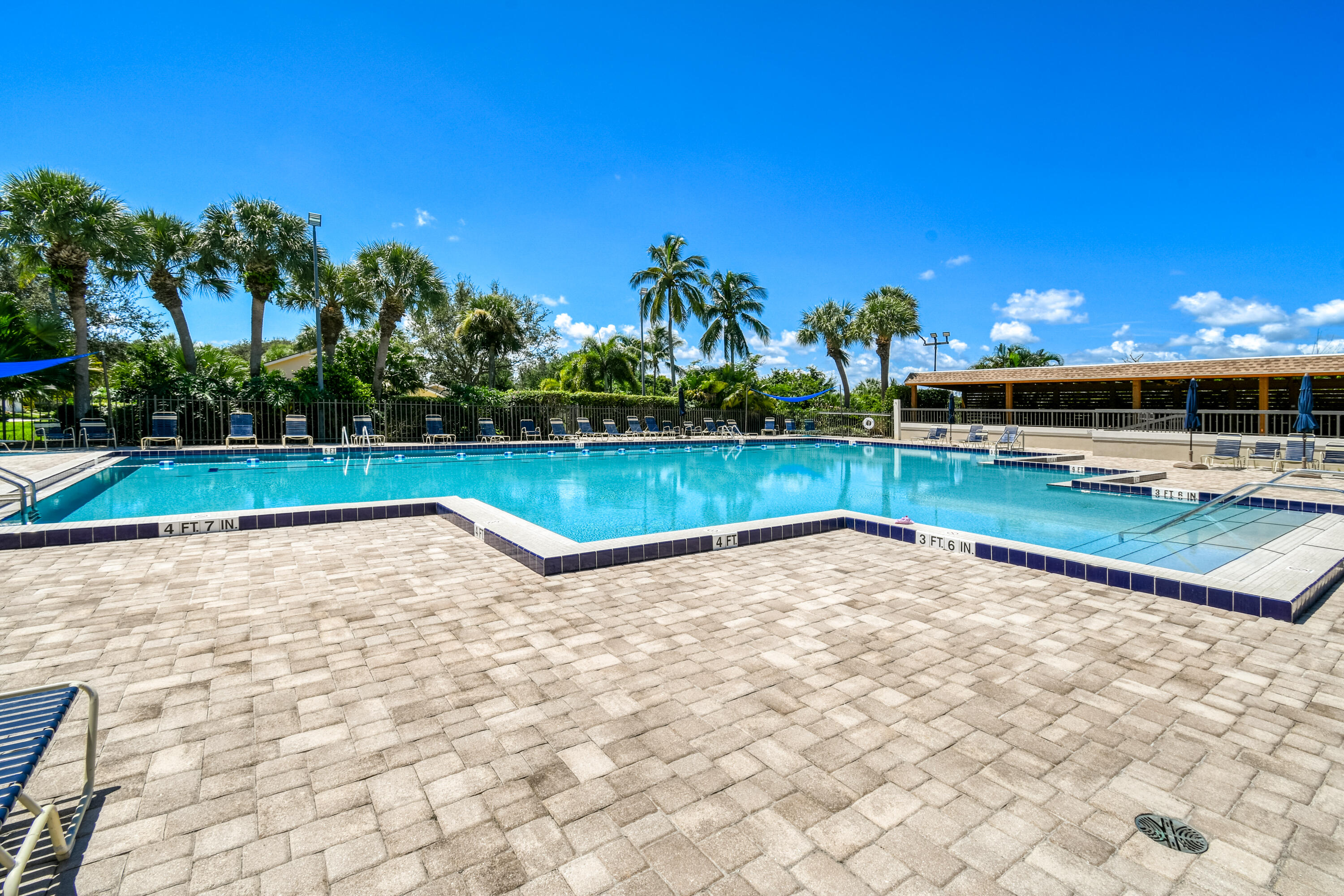 438 River Edge Road Jupiter, FL 33477 - Photo 68 of 80 a view of a swimming pool and lounge chairs