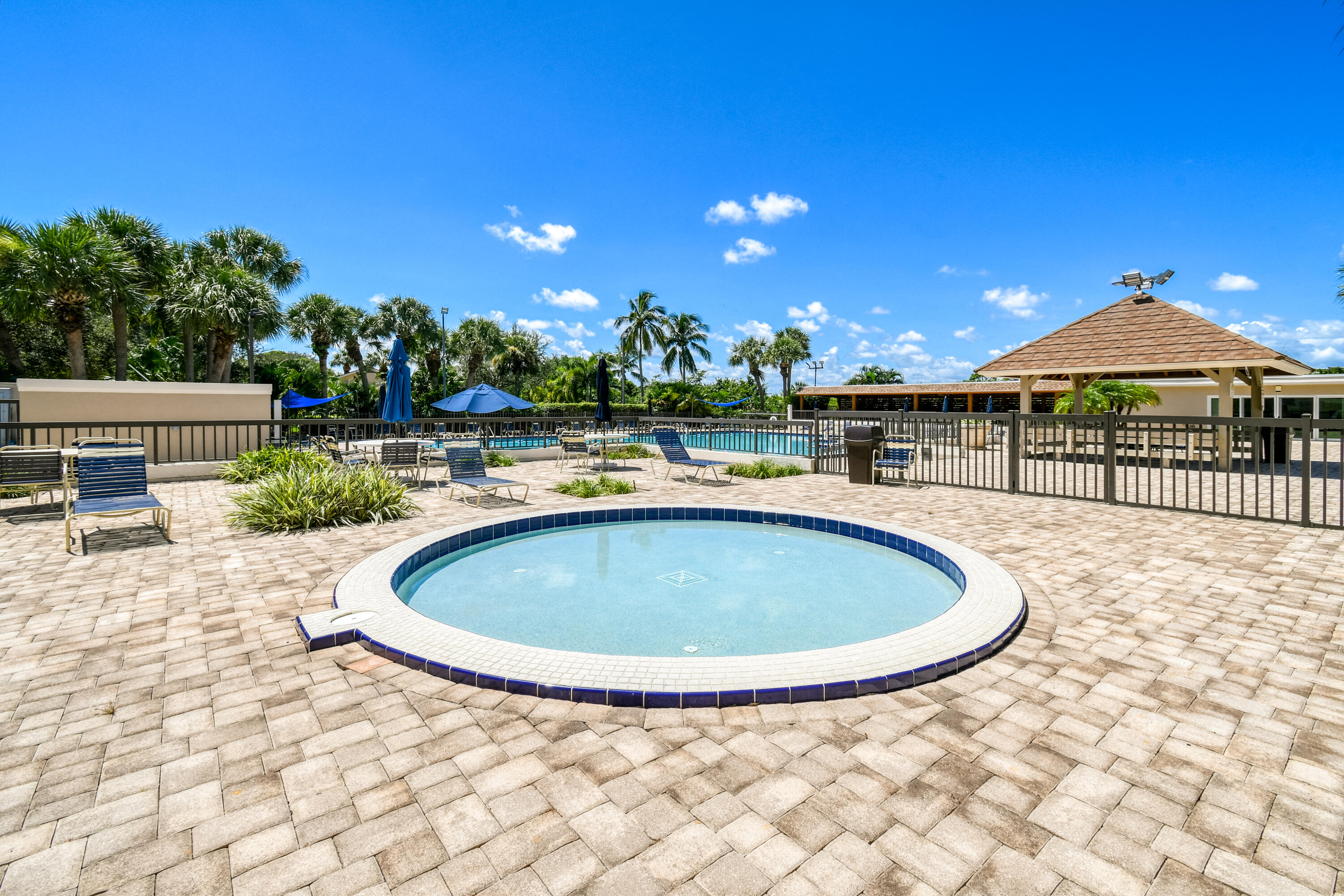438 River Edge Road Jupiter, FL 33477 - Photo 71 of 80 a view of a swimming pool with a patio