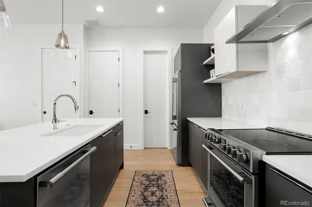a kitchen with a sink stove and refrigerator