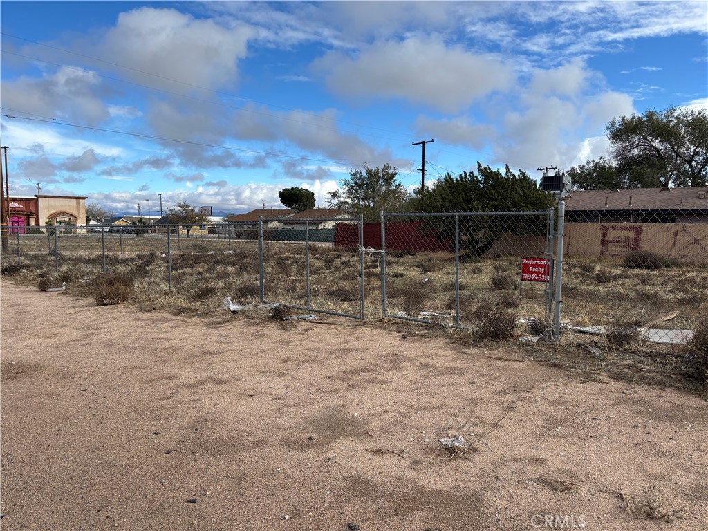 -3rd Southwest 3-rd Sw 3rd Street Hesperia, CA 92345 - Photo 1 of 2 a view of a dry yard with wooden fence