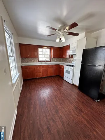 a view of kitchen with sink and wooden floor