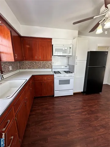 a kitchen with a sink and a stove top oven