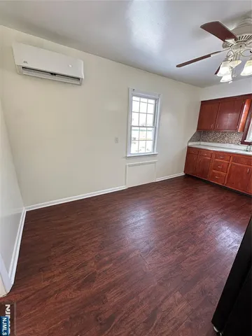 a view of room with hardwood floor and window