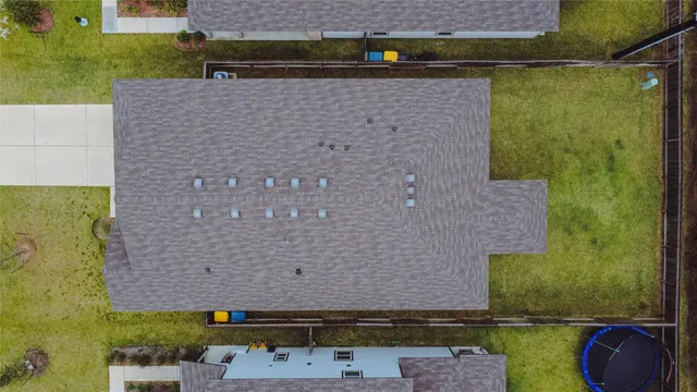 a aerial view of a house with a yard