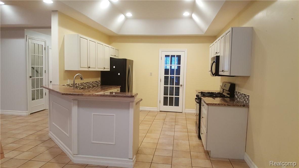 9118 Rucker Road Grosse Ile, MI 48138 - Photo 11 of 47 Kitchen with tray ceiling.