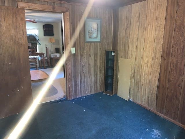 a view of a hallway with entryway wooden floor and front door