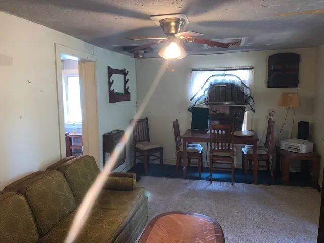 a living room with furniture and a staircase