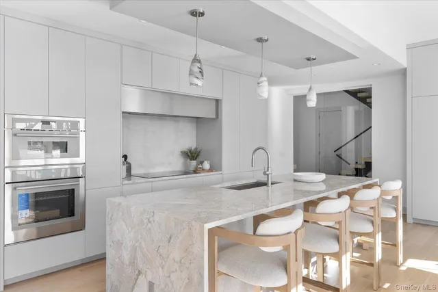 a kitchen with a sink stove and cabinets