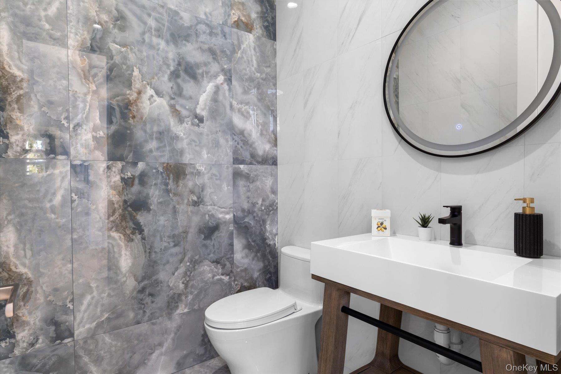 1750 Hobart Road Southold, NY 11971 - Photo 15 of 41 a bathroom with a sink and a mirror