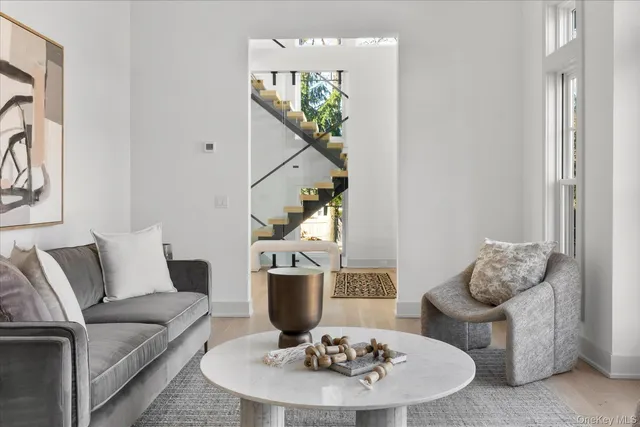 a living room with furniture and white wooden floor
