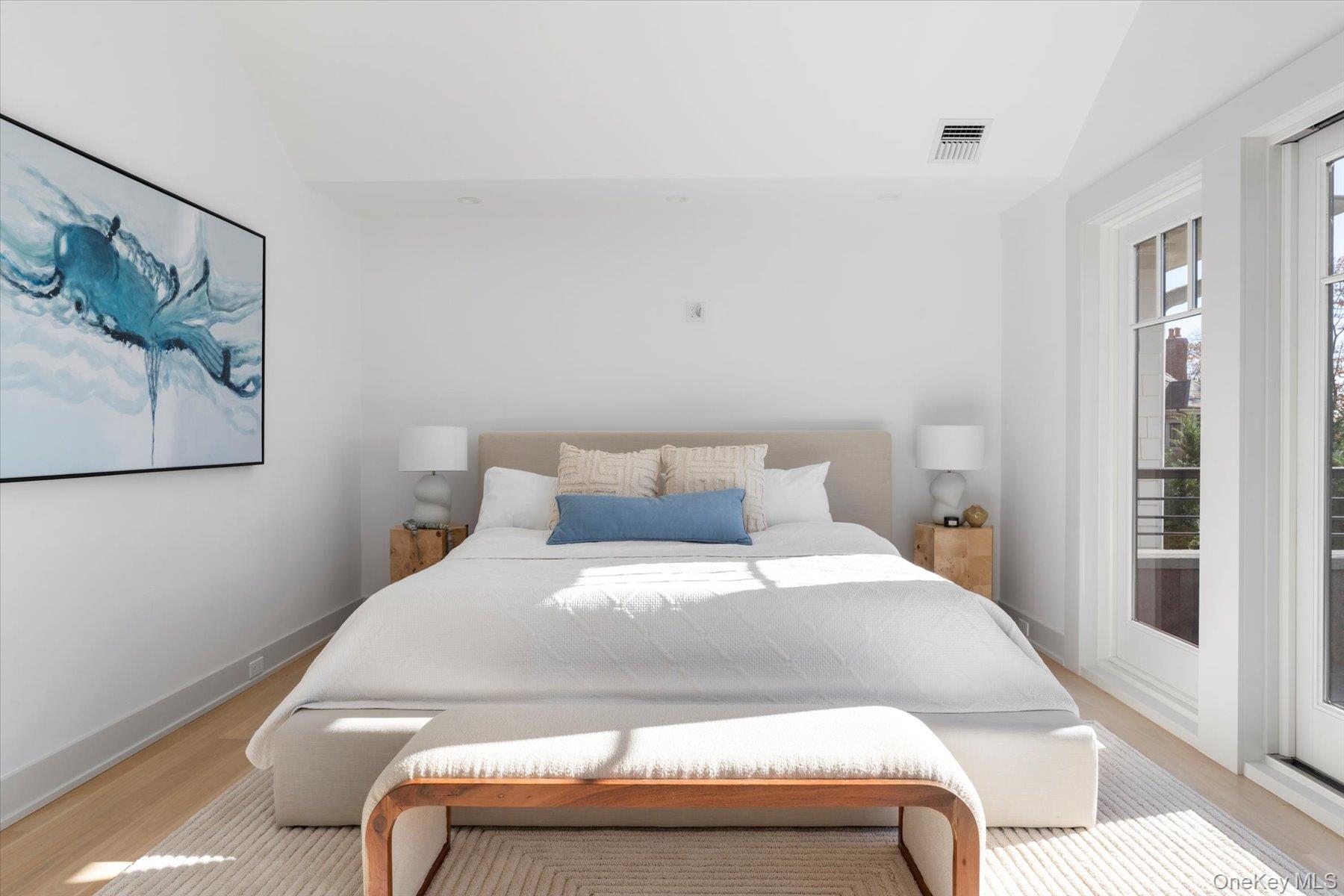 1750 Hobart Road Southold, NY 11971 - Photo 22 of 41 a bedroom with a bed and painting on the wall